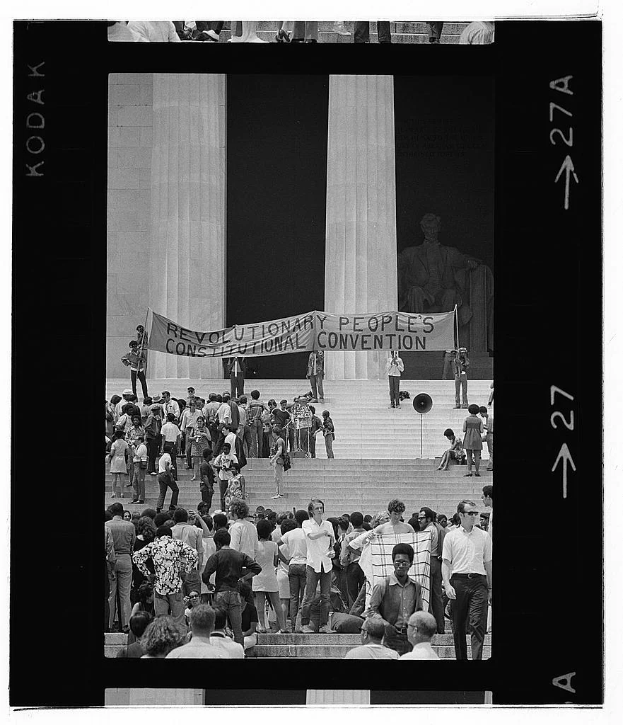 People gather on the Lincoln Memorial steps under a Revolutionary People’s Constitutional Convention banner in 1970.
