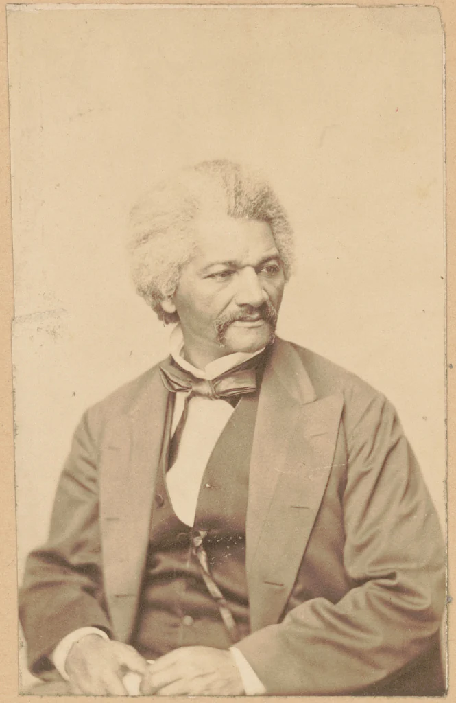 Frederick Douglass seated in an 1870 studio portrait, facing right.